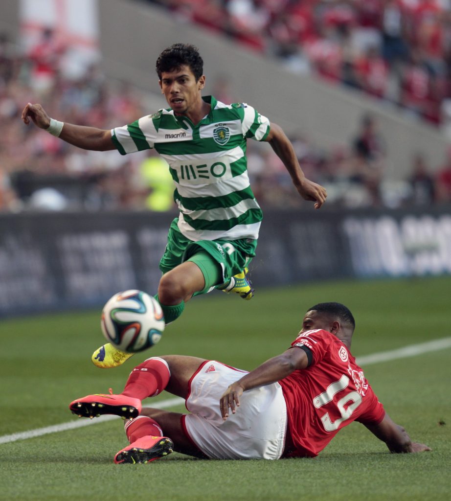 Benfica's Santos fights for the ball with Sporting's Martins during their Portuguese Premier League match in Lisbon